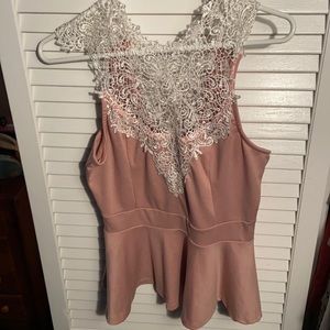 Pink sleeveless top with white lace.